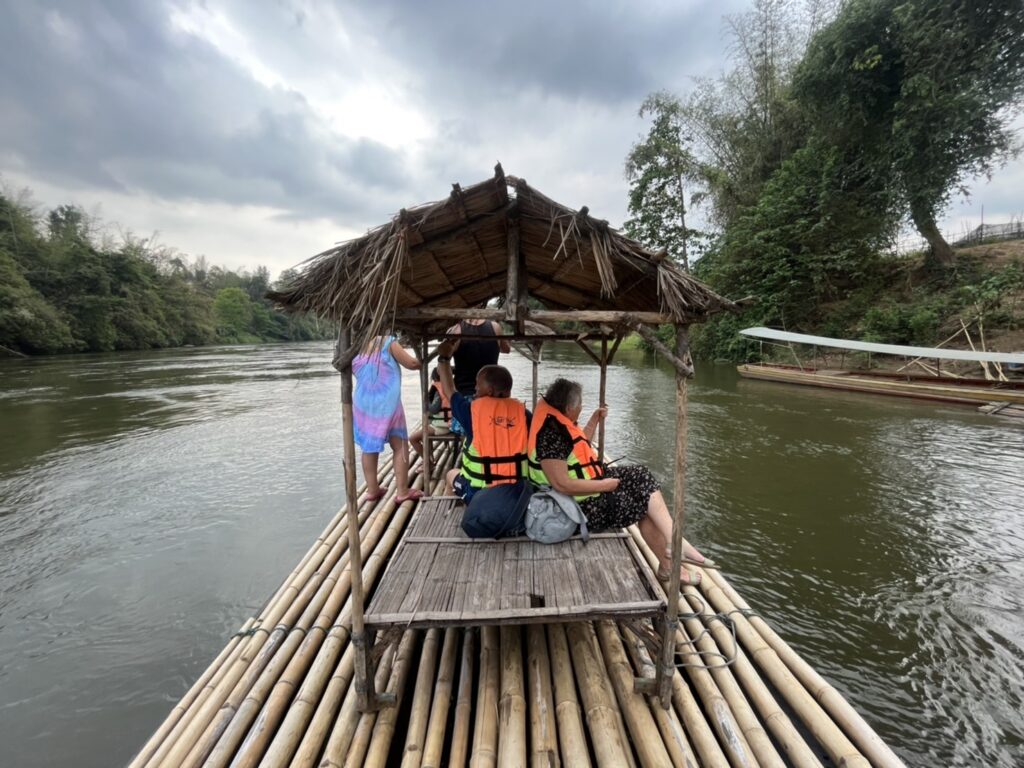 People bamboo rafting along the River Kwai near Kanchanaburi.