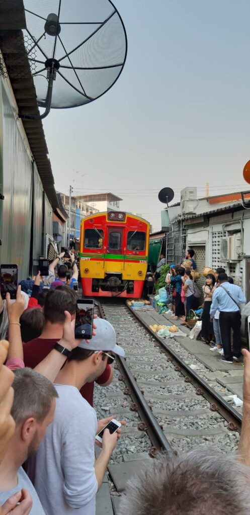 Train arriving at Mae Klong Railway Market.