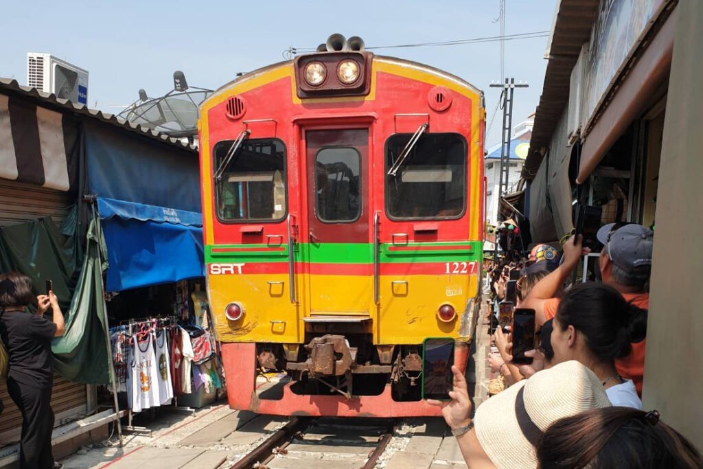 Train arriving at Mae Klong Railway Market.